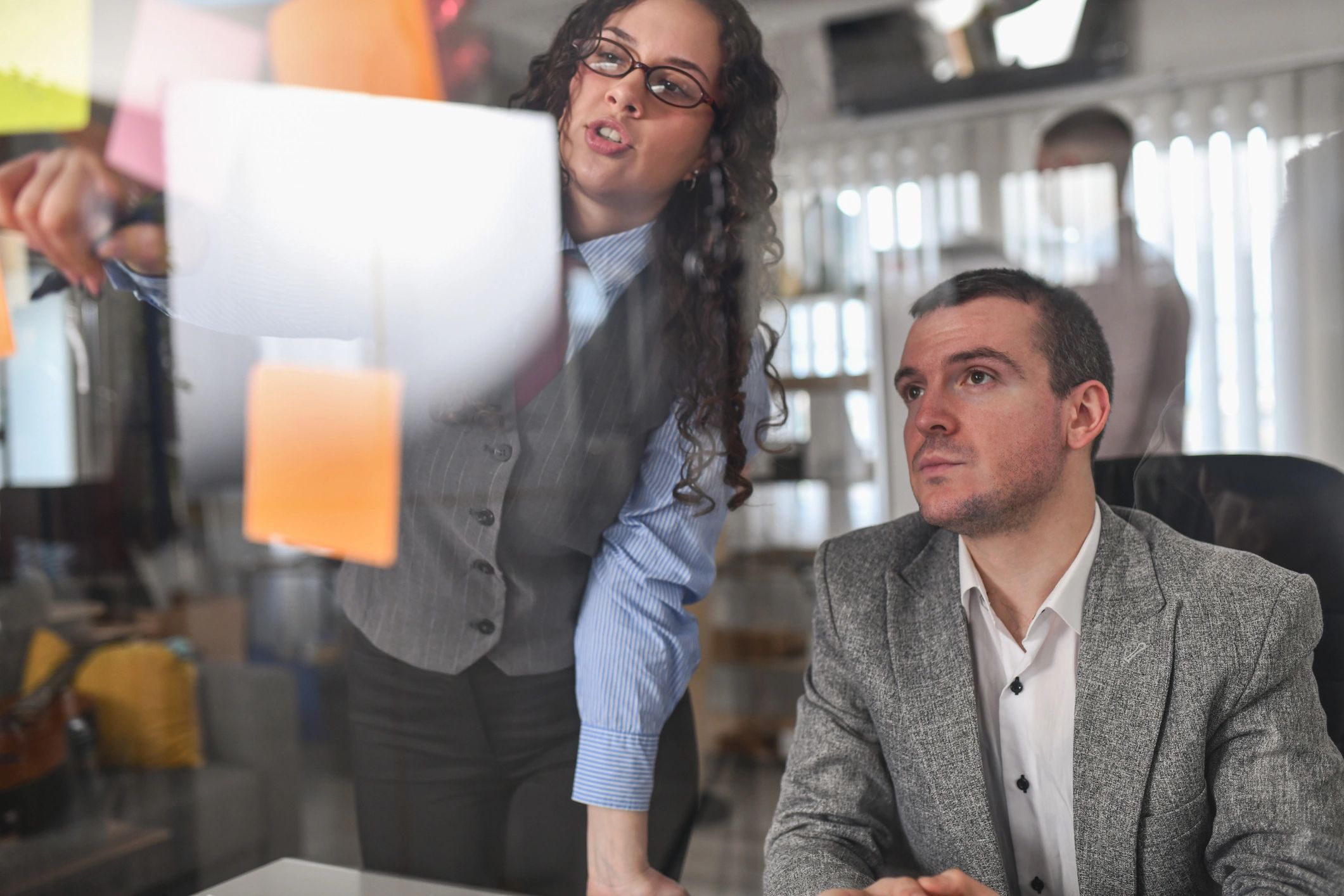 Team planning with sticky notes on a glass board